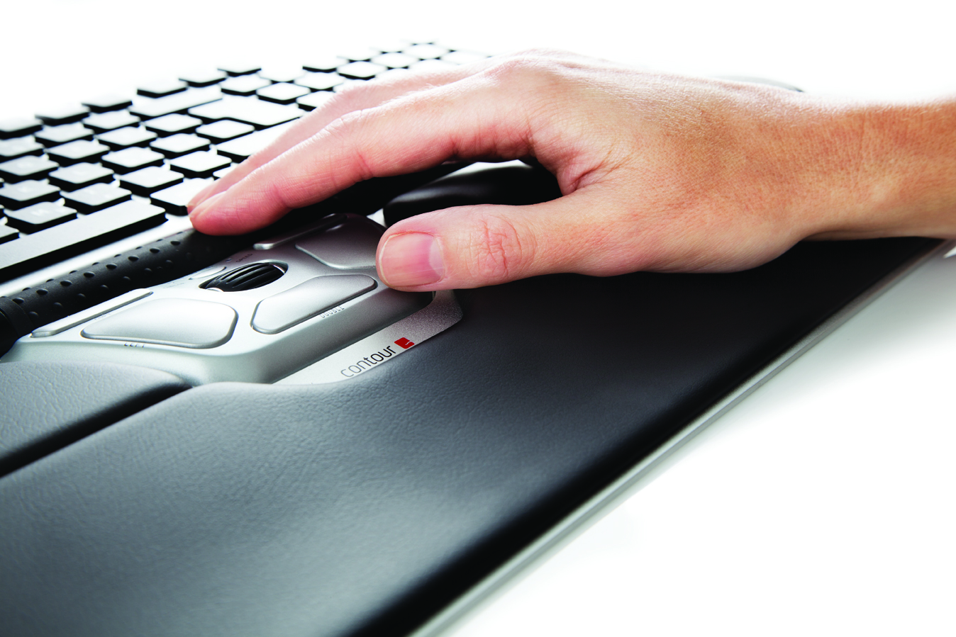 Close-up of a hand resting on the extended palm support of the RollerMouse Red Plus