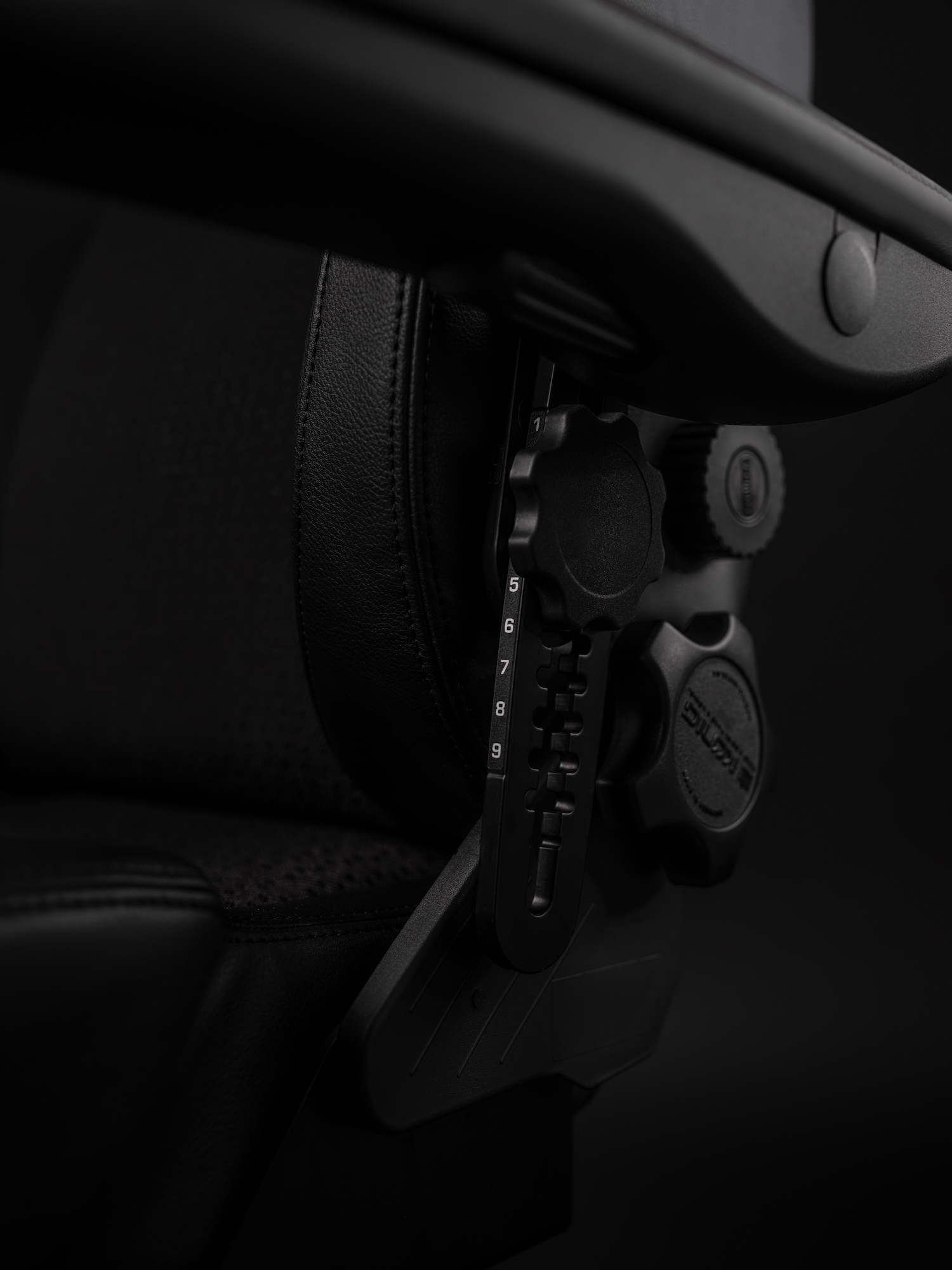 Close-up of the adjustable armrest and lumbar support controls on the RH Secur24